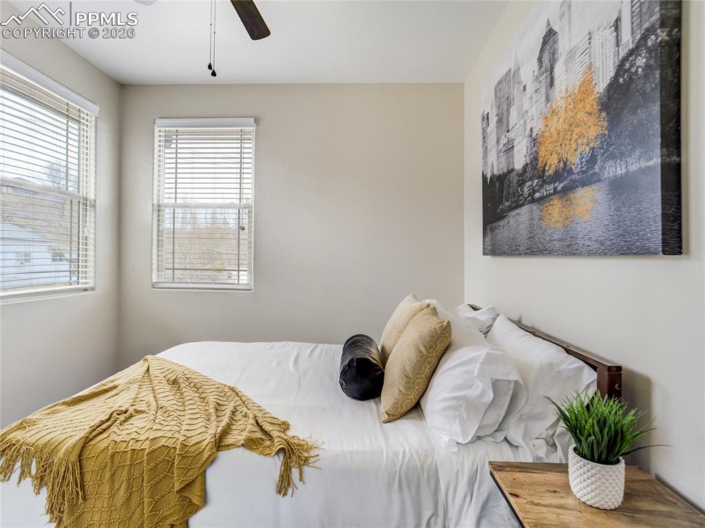 Image 35 of 47: 4th bedroom on the upper level features beautiful corner windows to capture