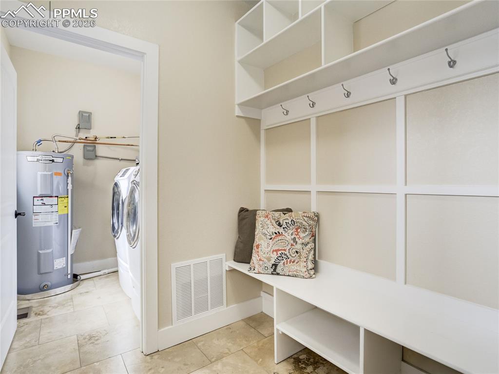 Image 38 of 47: Stylish mud room off of the garage allows for the perfect place for coats, 