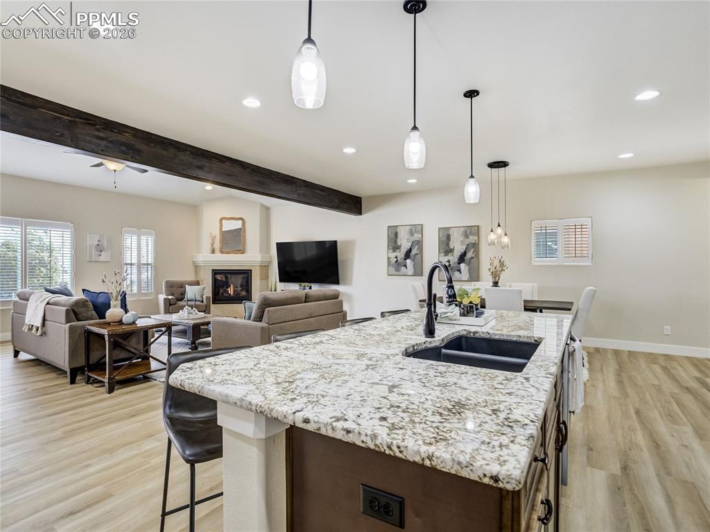Image 6 of 47: Designed for gathering, the kitchen island anchors the kitchen while openin