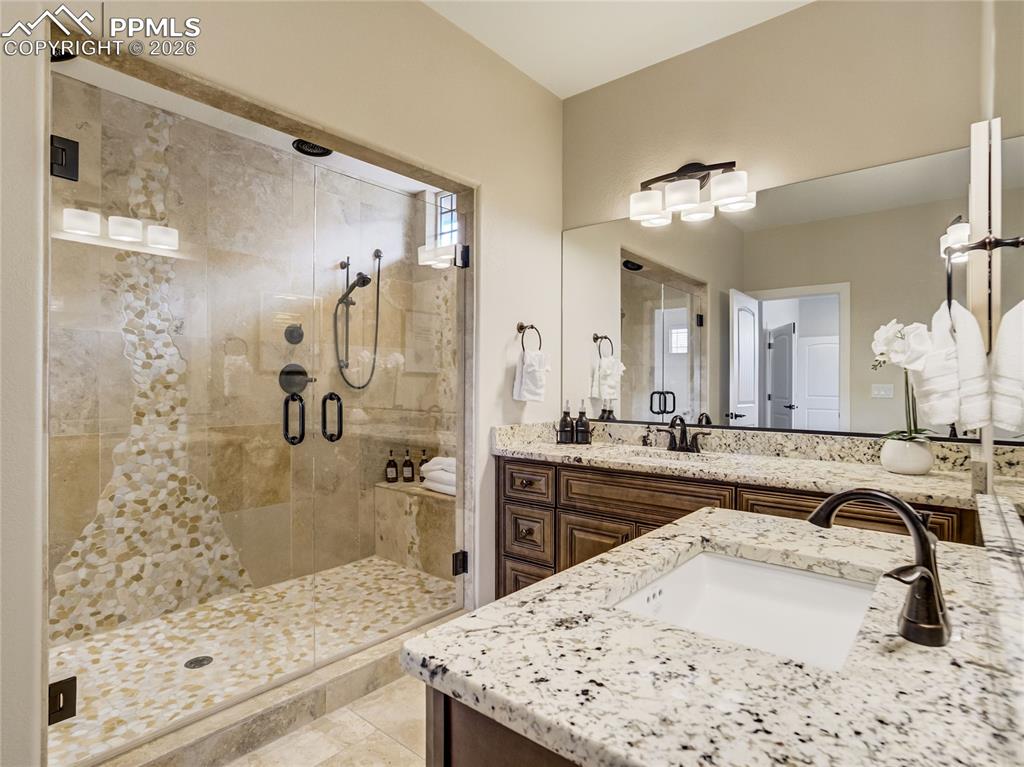 Image 9 of 47: Primary bath features split granite vanities, and a spacious walk-in double