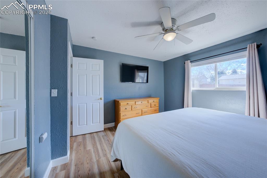 Image 14 of 35: Bedroom with light wood-style flooring and a ceiling fan