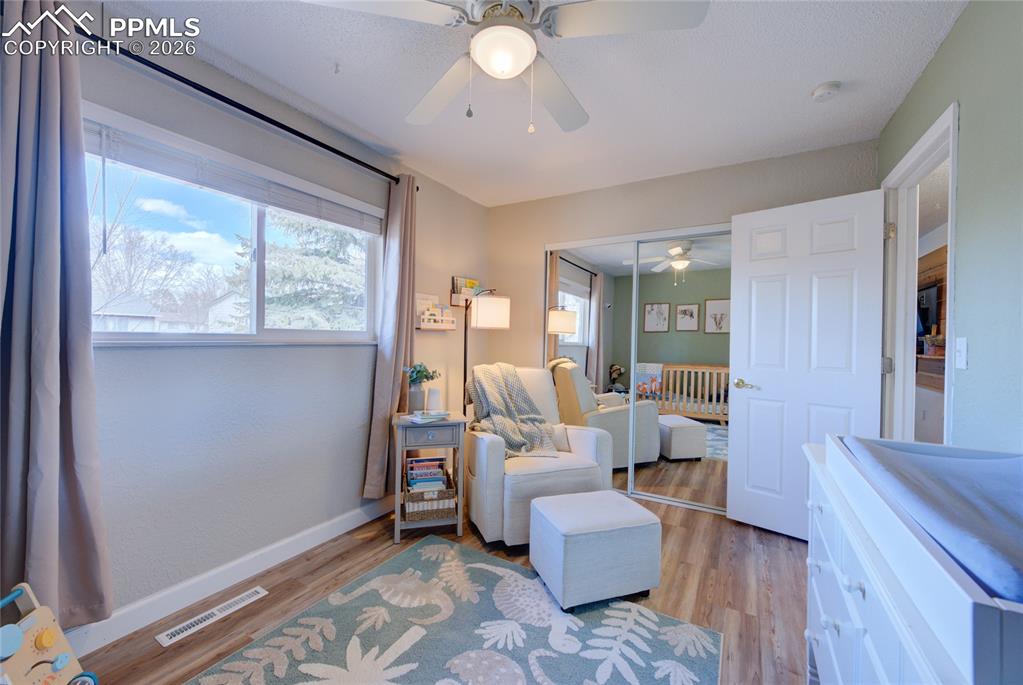 Image 15 of 35: Bedroom with wood finished floors, a ceiling fan, and a closet