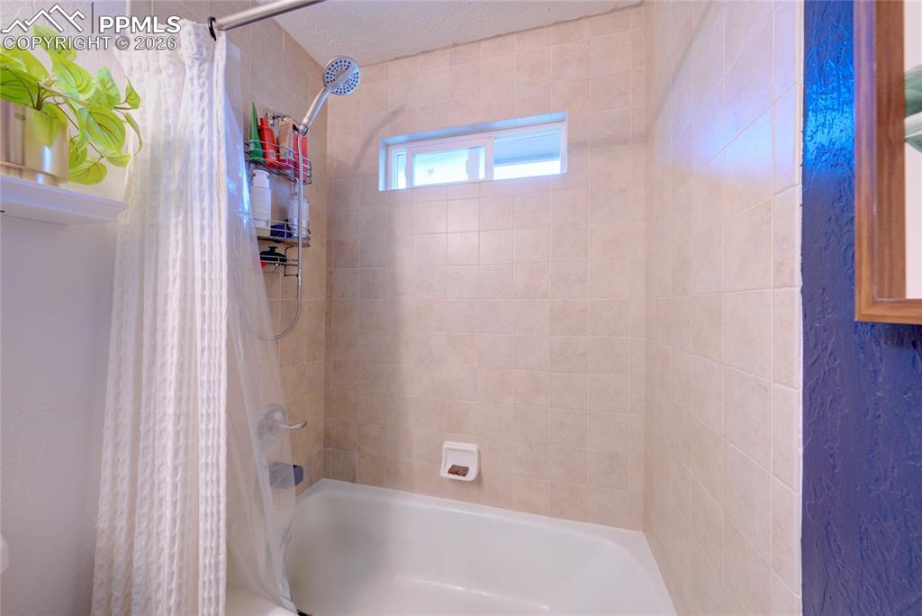 Image 18 of 35: Full bathroom featuring shower / tub combo with curtain