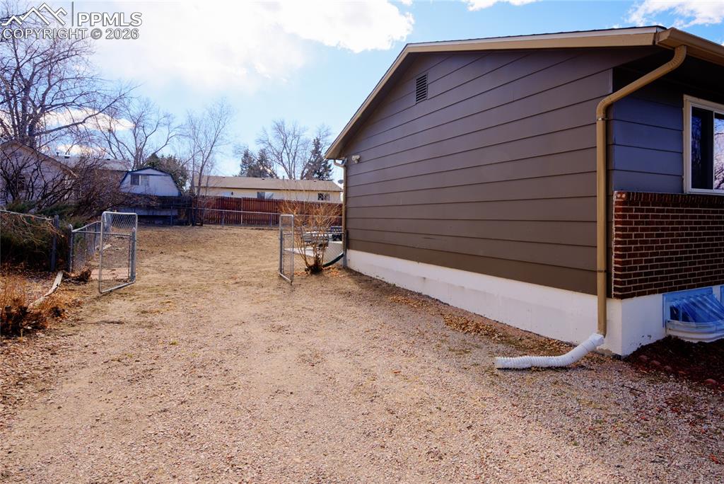 Image 35 of 35: View of property exterior featuring a gate