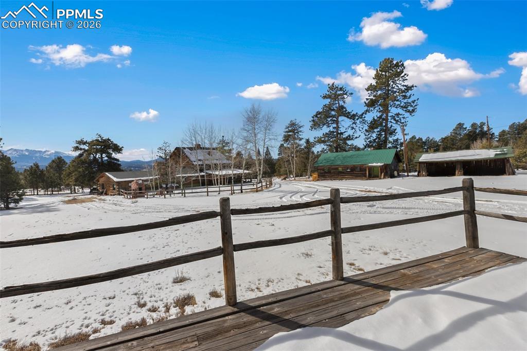 Image 39 of 50: Deck from the 2nd residence overlooking the primary residence, garage and y