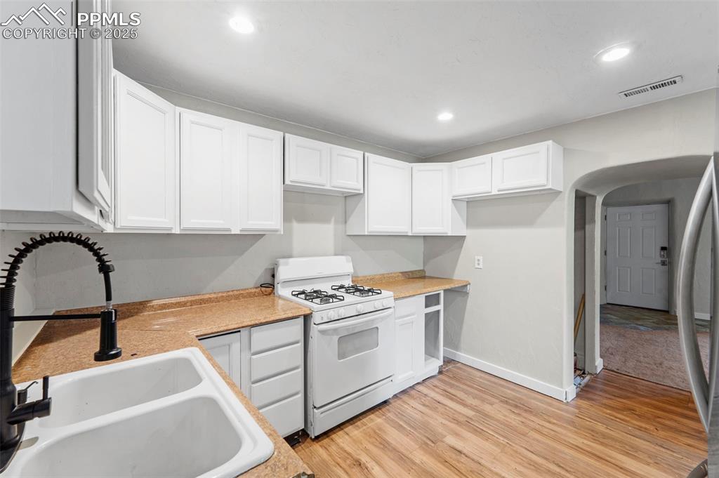 Image 12 of 35: Ample counter space and storage in this sleek, functional kitchen.