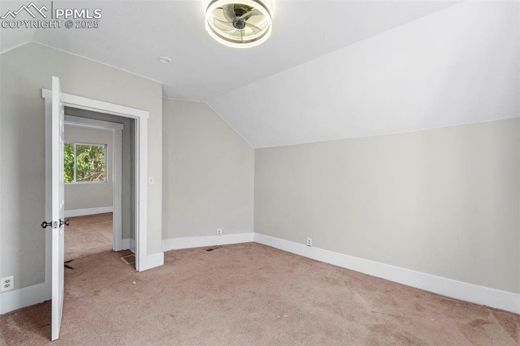 Image 19 of 35: Bedroom with neutral finishes and endless potential.