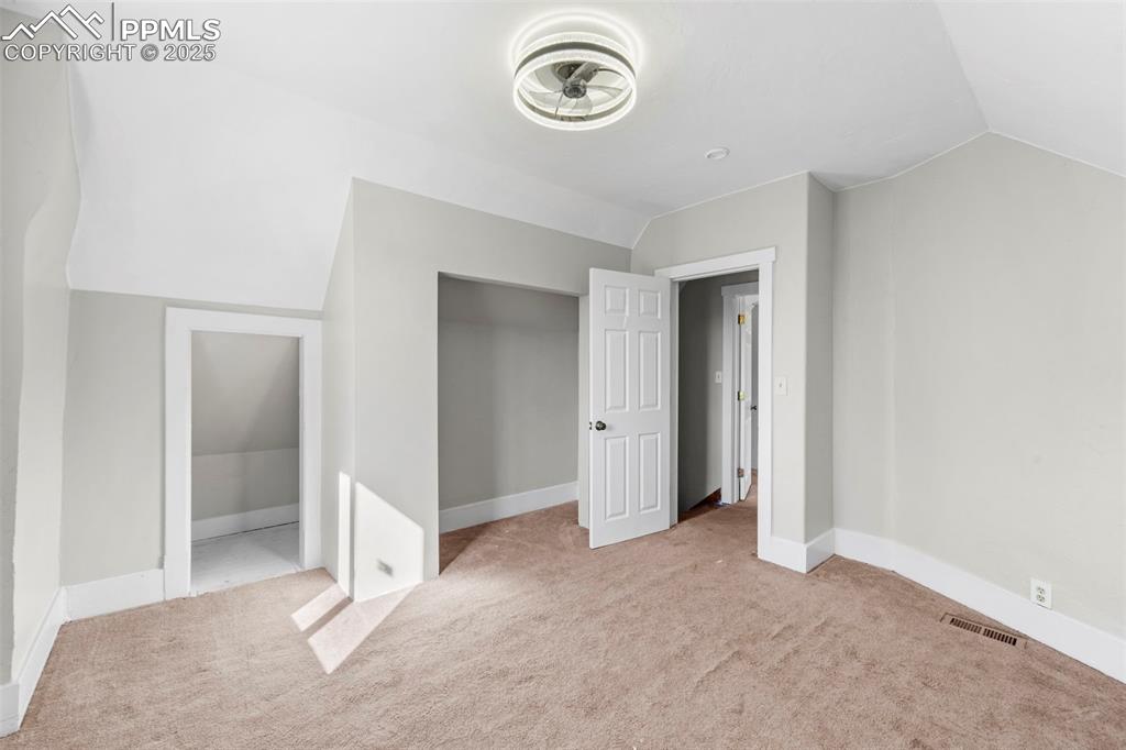 Image 20 of 35: Cozy bedroom with closet space and soft lighting.