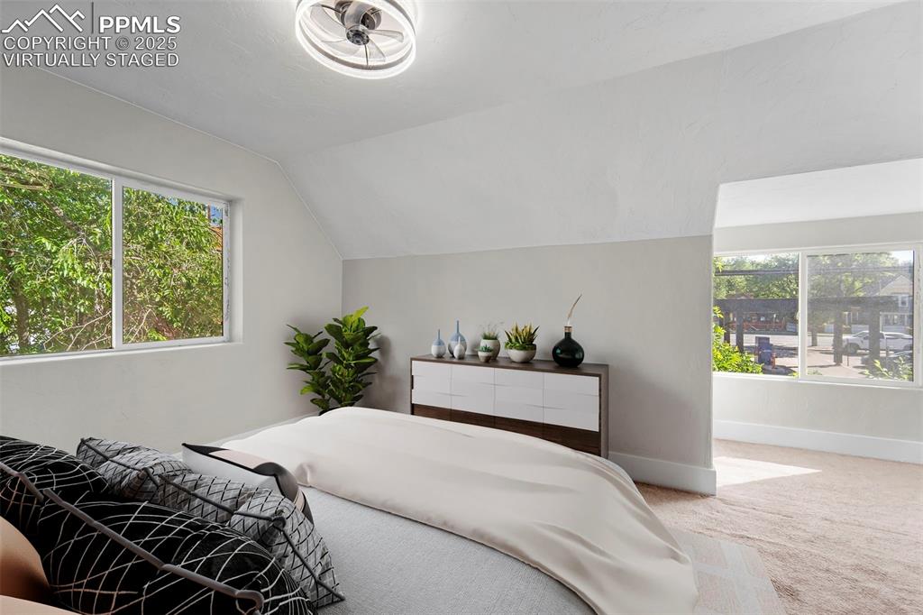 Image 22 of 35: Virtually Staged / Relaxing bedroom with soft carpeting and tranquil views.