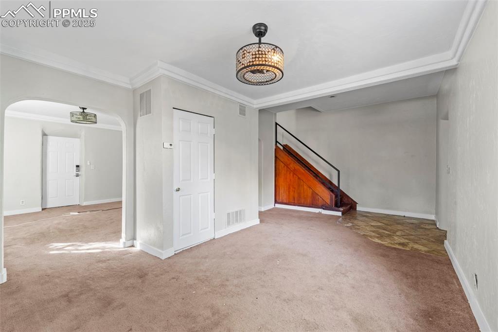 Image 3 of 35: Bright and inviting living room with updated lighting and warm flooring.