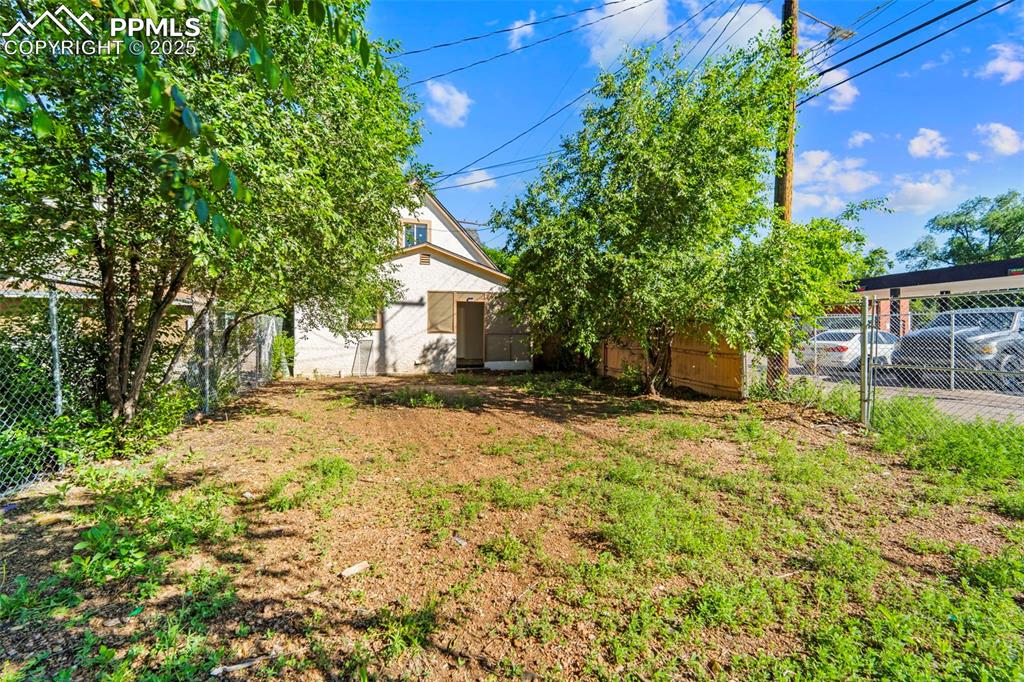 Image 30 of 35: Lush backyard with room to play or garden.