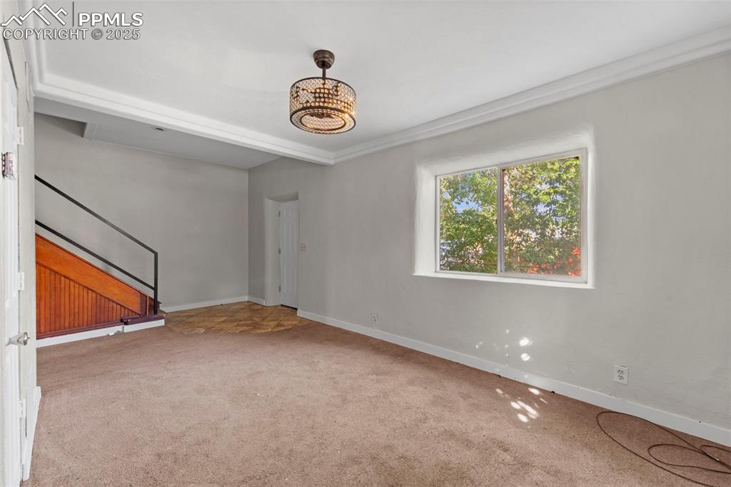 Image 6 of 35: Spacious living area with a large window overlooking the backyard.