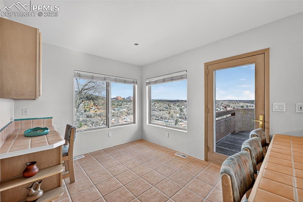 Image 17 of 50: Dining room featuring light tile patterned floors