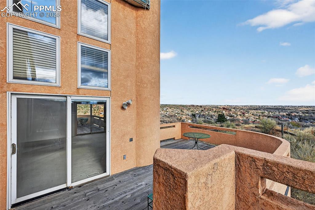 Image 25 of 50: View of wooden terrace outside of primary bedroom