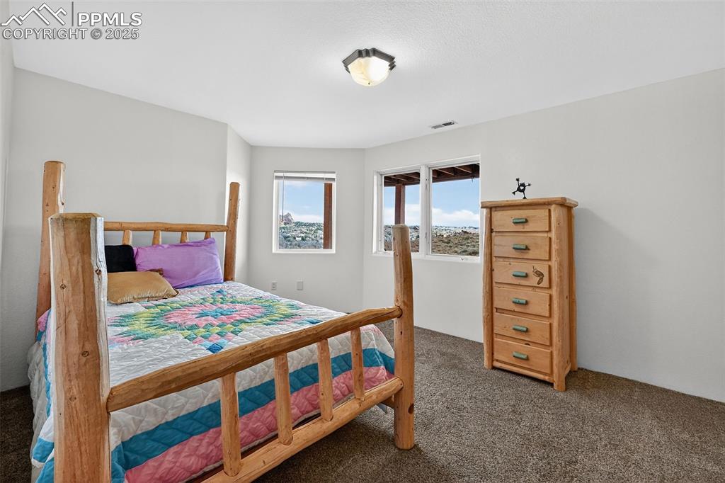 Image 39 of 50: Bedroom featuring dark carpet