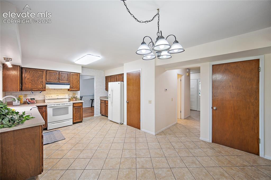 Image 15 of 42: Kitchen boasts plenty of cabinet and counter space with pantry. 