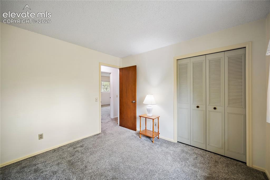 Image 27 of 42: Upstairs bedroom with carpet and good sized closet
