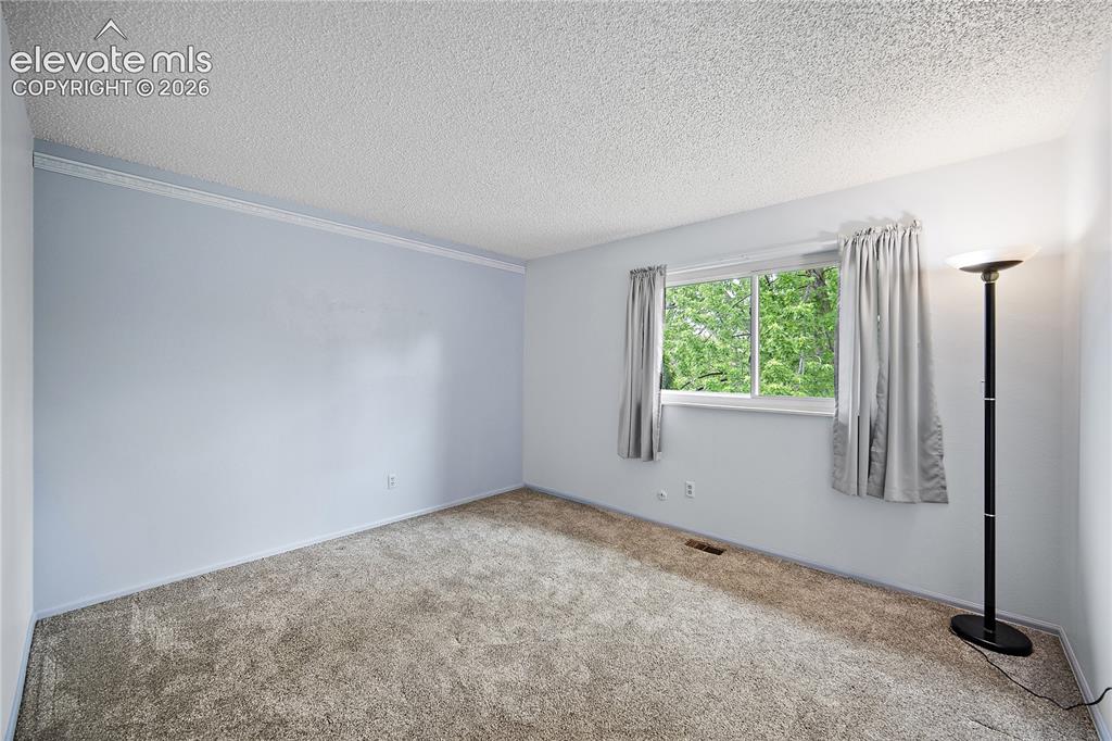 Image 30 of 42: Upstairs bedroom with carpet.