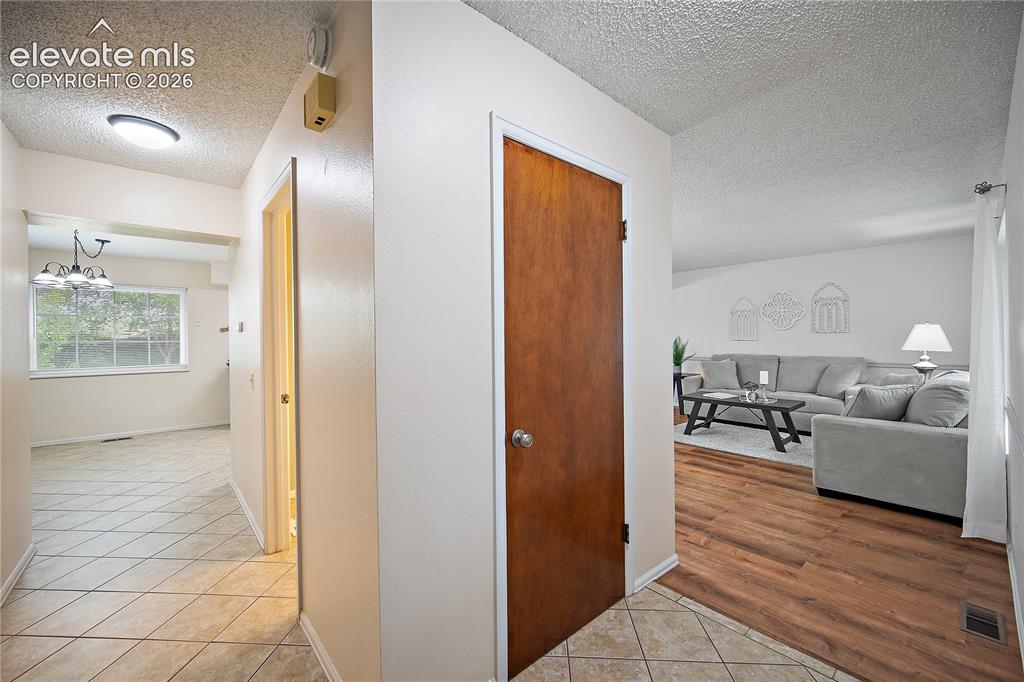 Image 5 of 42: Main entry with tile flooring, closet and open to the living room. 