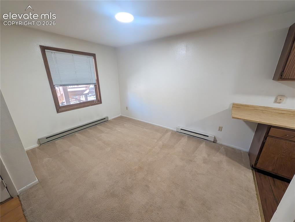 Image 12 of 30: Carpeted flooring, recessed ceiling lighting, a window with wood trim, and 