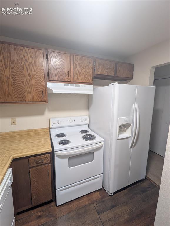 Image 13 of 30: Kitchen featuring wood-finish flooring, wood cabinetry, light-toned counter