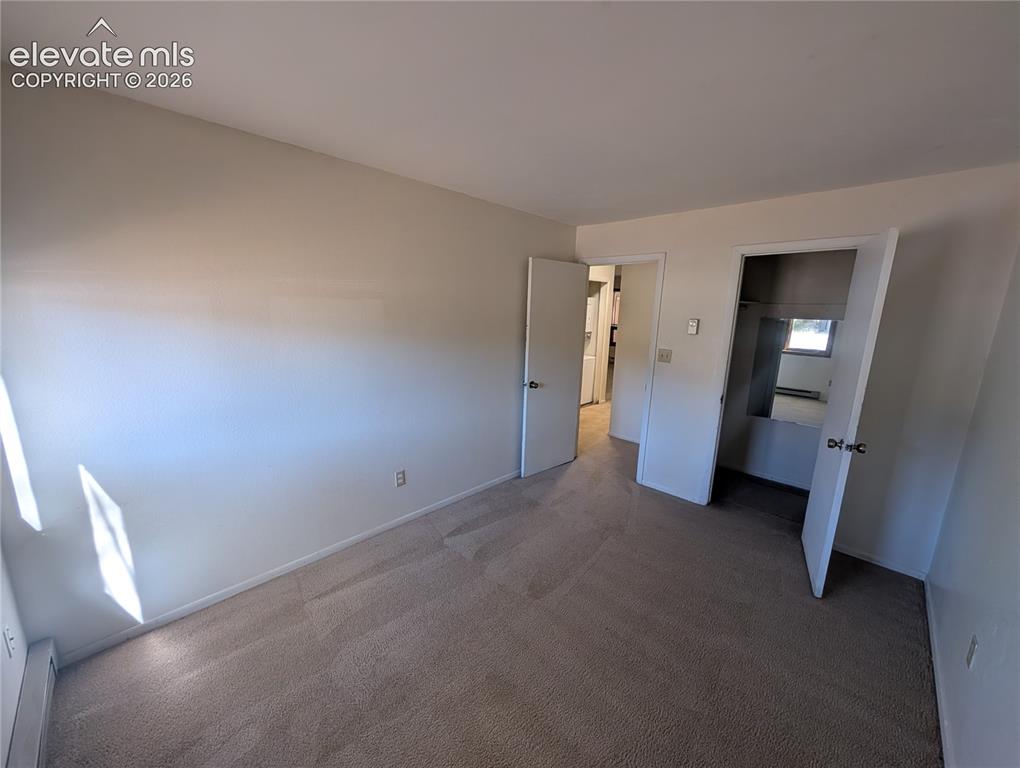 Image 16 of 30: Wall-to-wall carpeting, neutral wall finishes, and solid core doors