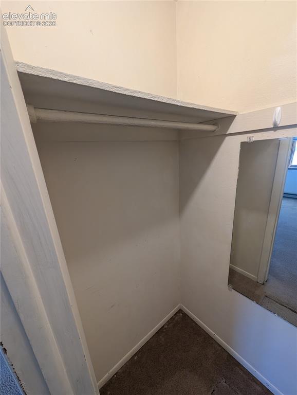 Image 19 of 30: Built-in closet with integrated shelving and hanging rod