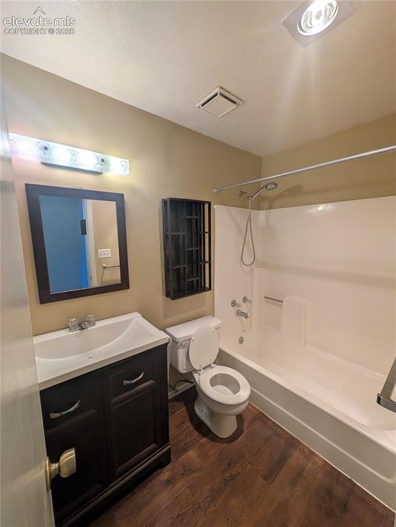 Image 22 of 30: Wood-finish flooring, dark wood-finish vanity with an integrated sink, fram