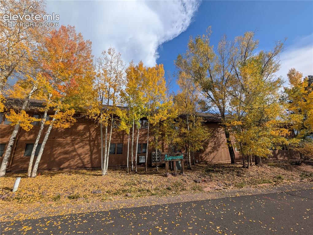Image 30 of 30: Two-story property featuring brown siding and multiple windows