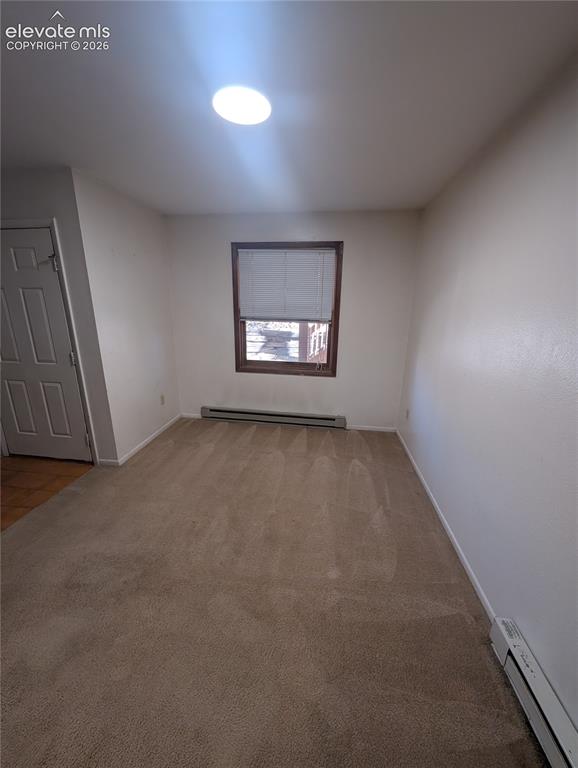 Image 9 of 30: Recessed ceiling lighting, wood-framed window, baseboard heating units, and