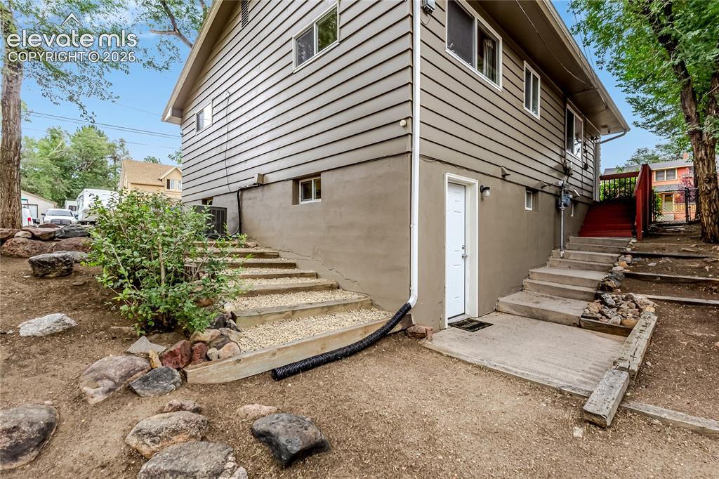 Image 41 of 49: Back of the home showing the entry to the lower level