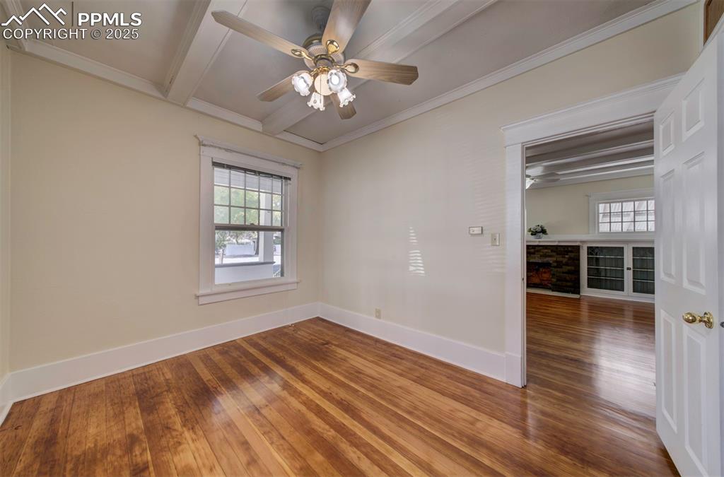 Image 32 of 40: Empty room with a ceiling fan, hardwood / wood-style flooring, beamed ceili