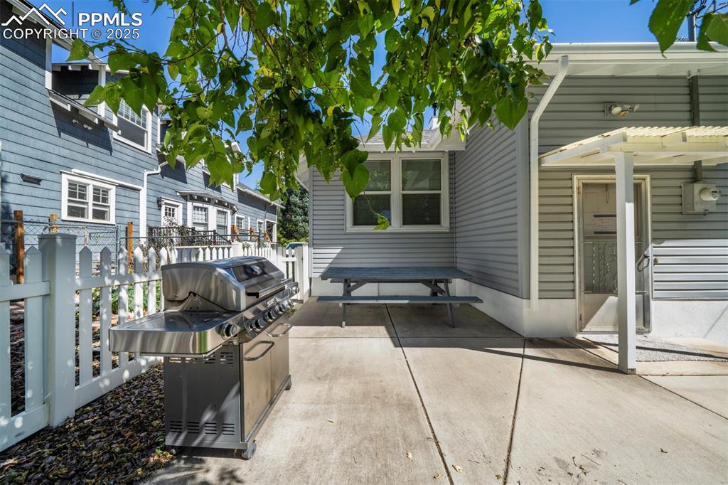 Image 4 of 40: View of patio / terrace featuring a pergola and grilling area