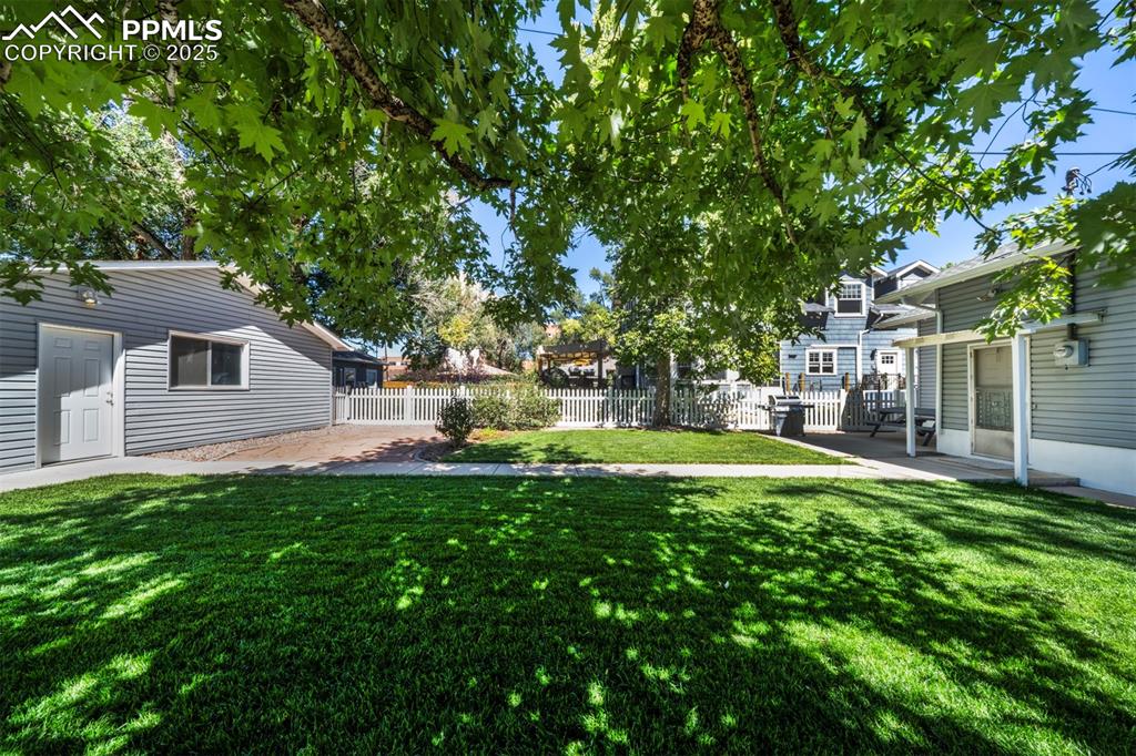 Image 6 of 40: View of yard with a patio