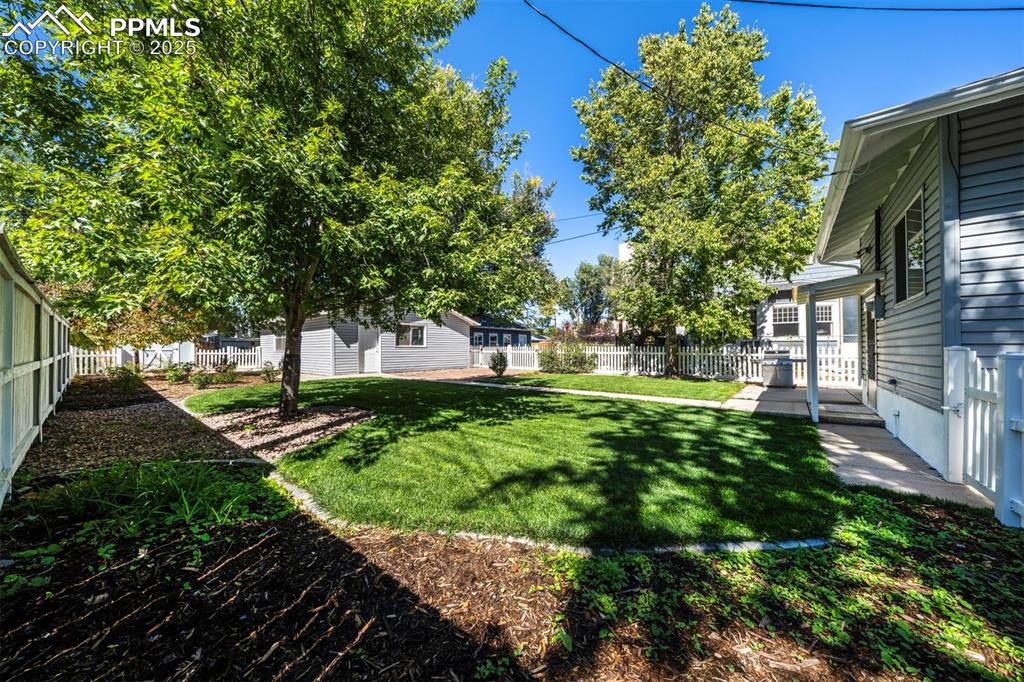 Image 7 of 40: View of fenced backyard