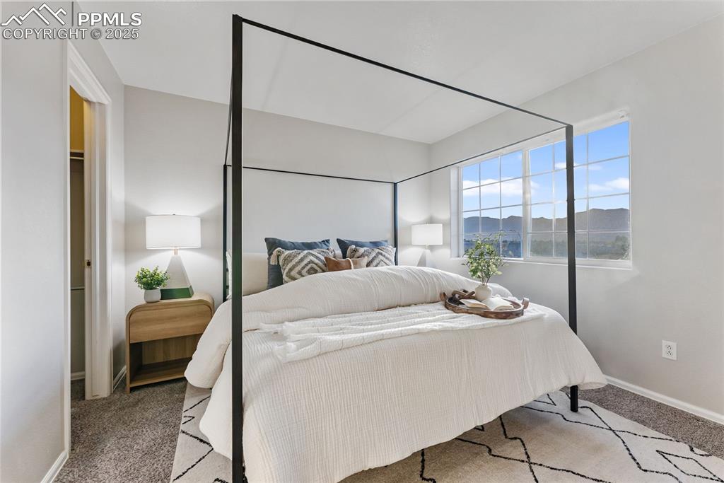 Image 14 of 45: Carpeted bedroom featuring baseboards and a mountain view