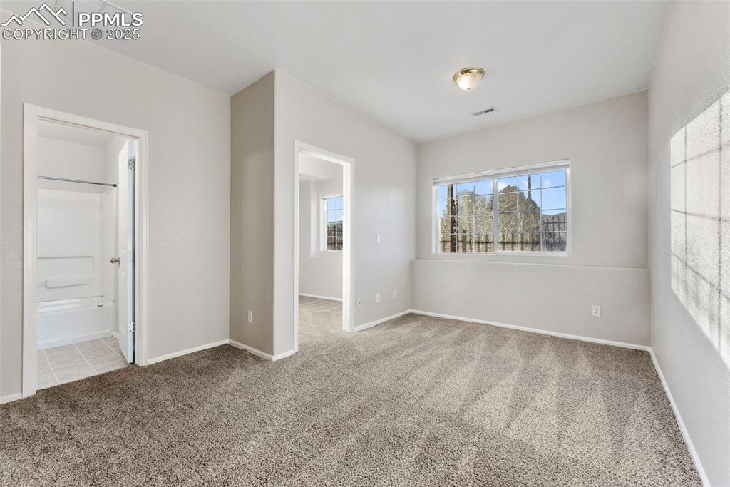 Image 29 of 45: Unfurnished bedroom featuring light colored carpet and ensuite bath
