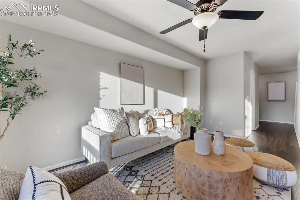 Image 7 of 45: Living room with wood finished floors and a ceiling fan