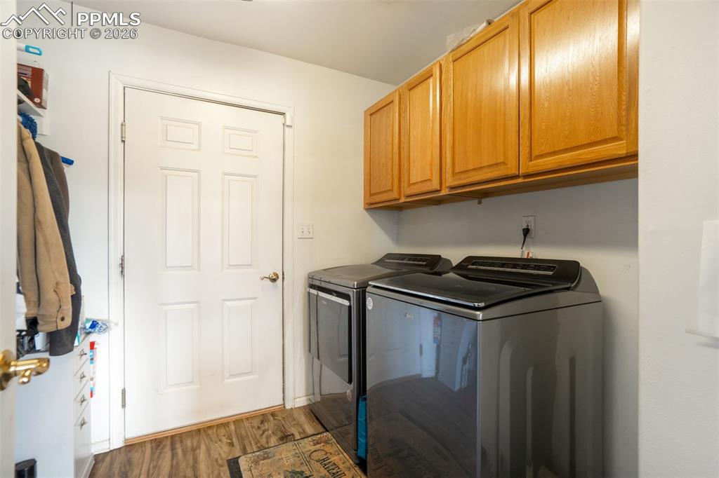 Image 16 of 50: Laundry room with cabinet space, and on main level