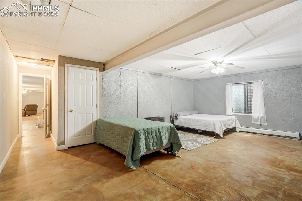 Image 34 of 50: Bedroom with finished concrete floors, a 2 closets and storage room