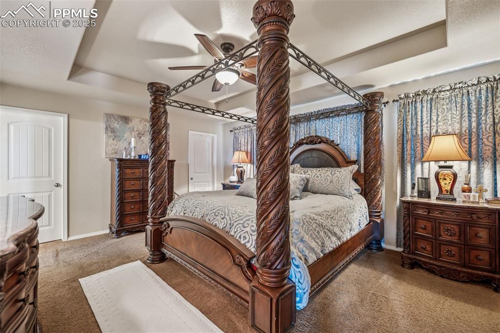 Image 10 of 20: Expansive primary bedroom with vaulted ceilings and generous space for furn