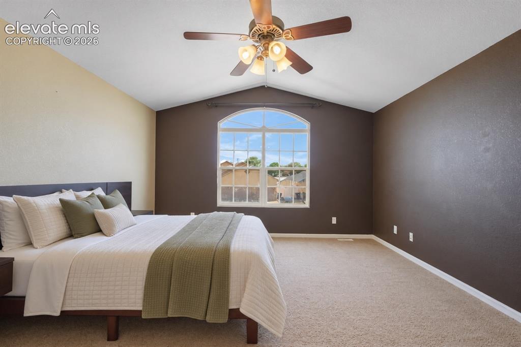 Image 22 of 49: Vaulted ceiling with an integrated ceiling fan and light fixture, arch-top