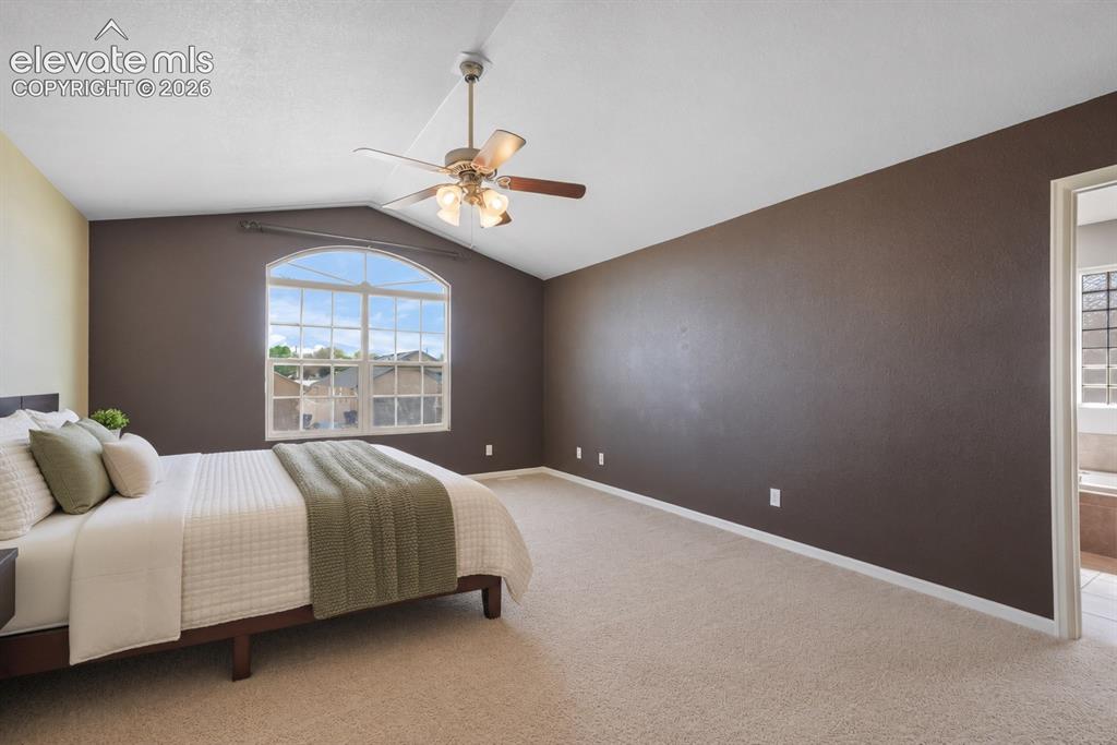 Image 23 of 49: Arched window, vaulted ceiling, ceiling fan with integrated lighting, wall-