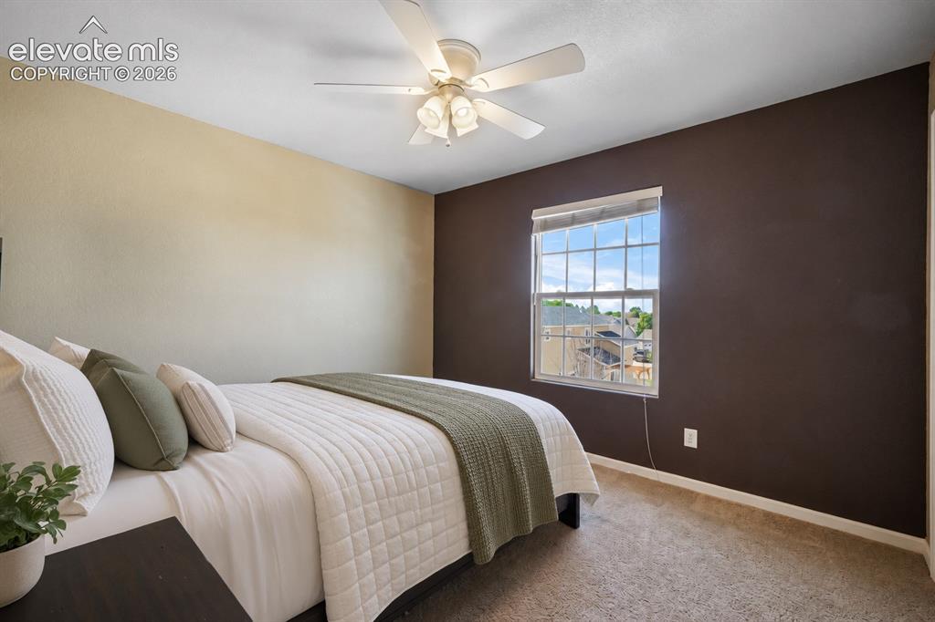 Image 28 of 49: Ceiling fan with integrated lighting, window with grid panes, textured carp