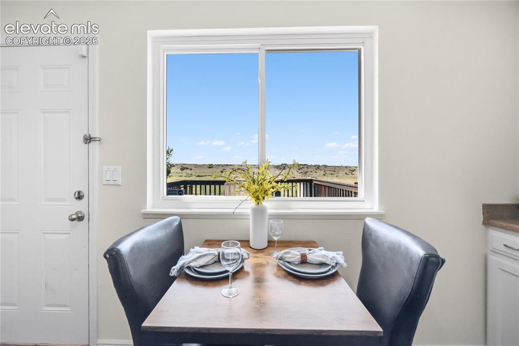 Image 10 of 31: Appliances include a smooth top range oven, vent hood, dishwasher, and side