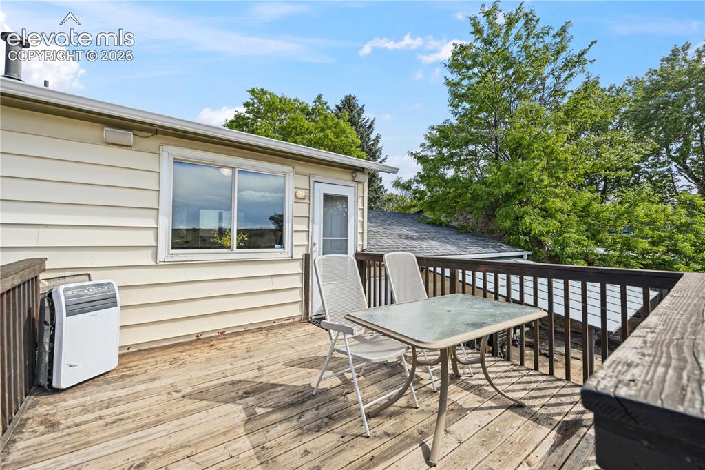 Image 12 of 31: Wood deck off the Kitchen for outdoor dining and relaxation.