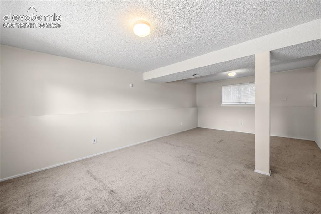 Image 20 of 31: Versatile Lower Level Family/Rec Room with neutral carpet.