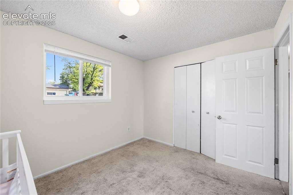 Image 26 of 31: Lower Level Bedroom #4 has neutral carpet.