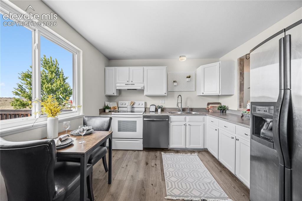 Image 8 of 31: Pass thru from the Living Room to the Kitchen with a breakfast bar for casu