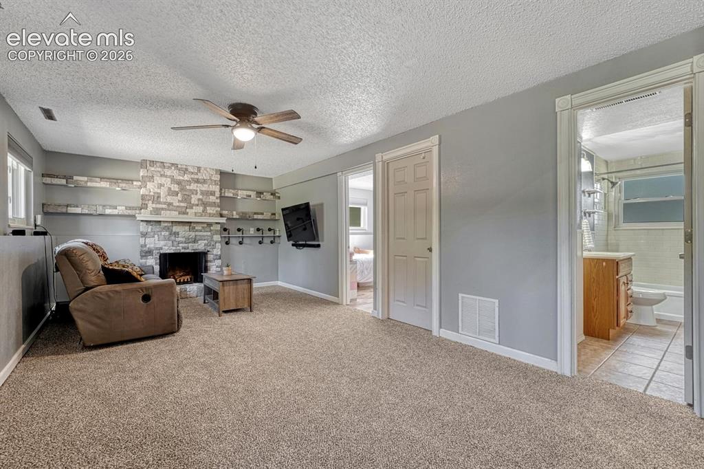 Image 14 of 50: The Lower Level Living Room features brand new carpet, a lighted ceiling fa